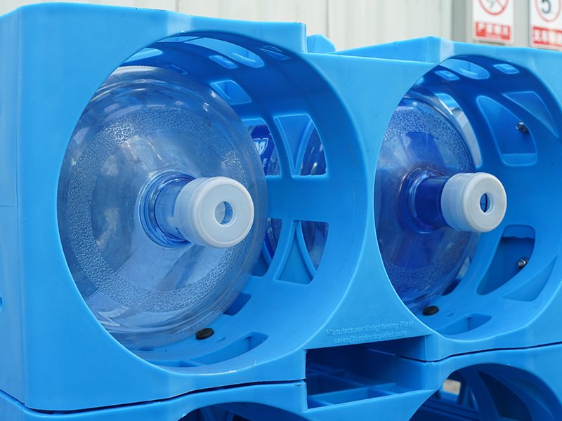 A close - up of blue plastic water racks, showcasing their design that provides 360 - degree protection for the large water bottles they hold.