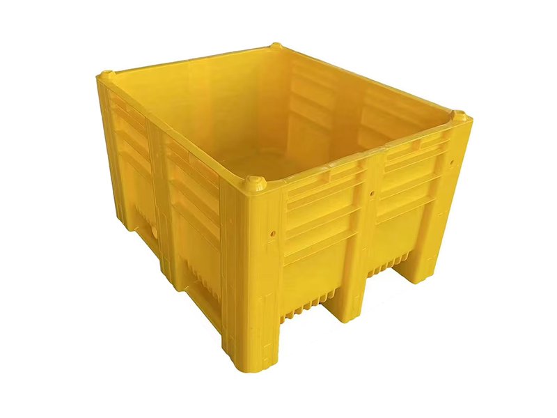 A yellow rigid plastic pallet box, emphasizing its sturdy, enclosed, and integrated design.