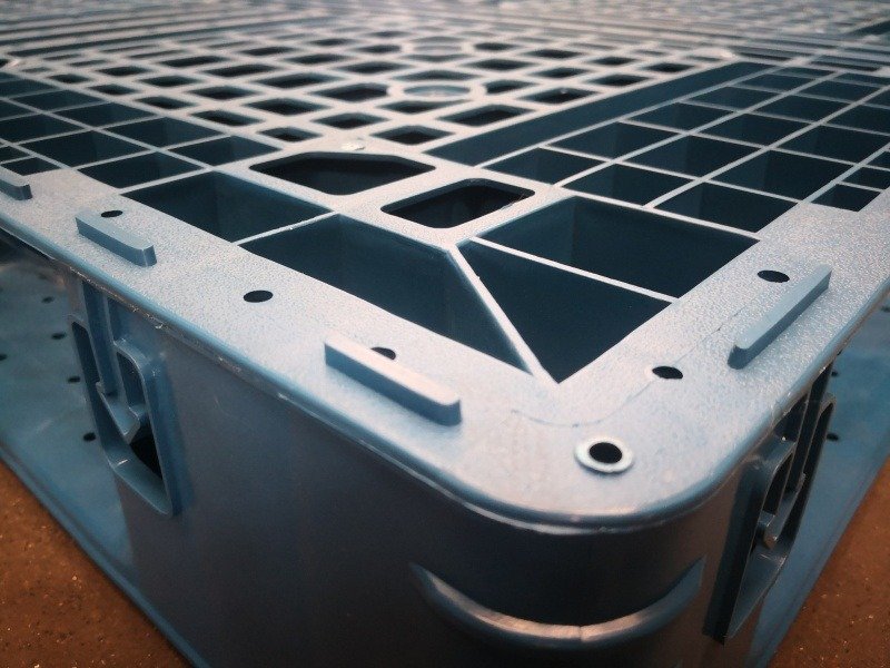 Double side blue plastic pallet, showcasing its grid - like structure and sturdy build, emphasizing our quality assurance.