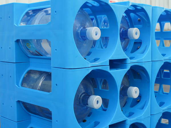 HDPE 5 gallon water jug rack holding three stacked water bottles per layer