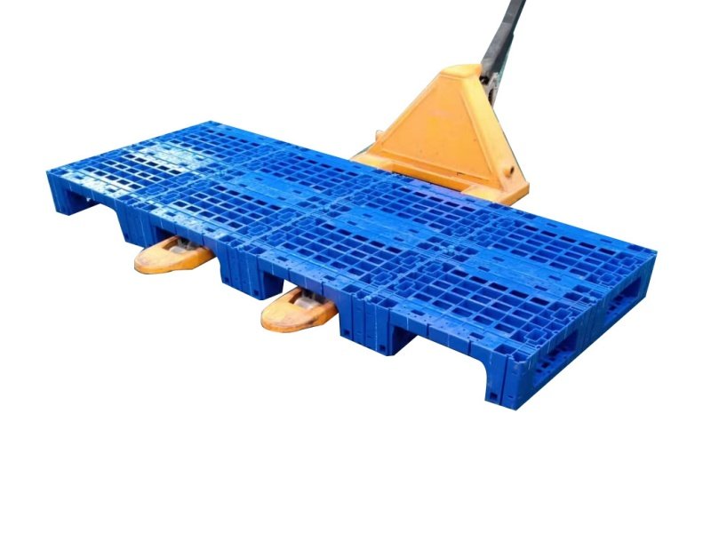 Modular plastic pallet lifted by pallet jack, showing four-way forklift entry design