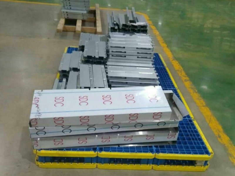 Metal items on blue - yellow splicing modular plastic pallets, solar industry.