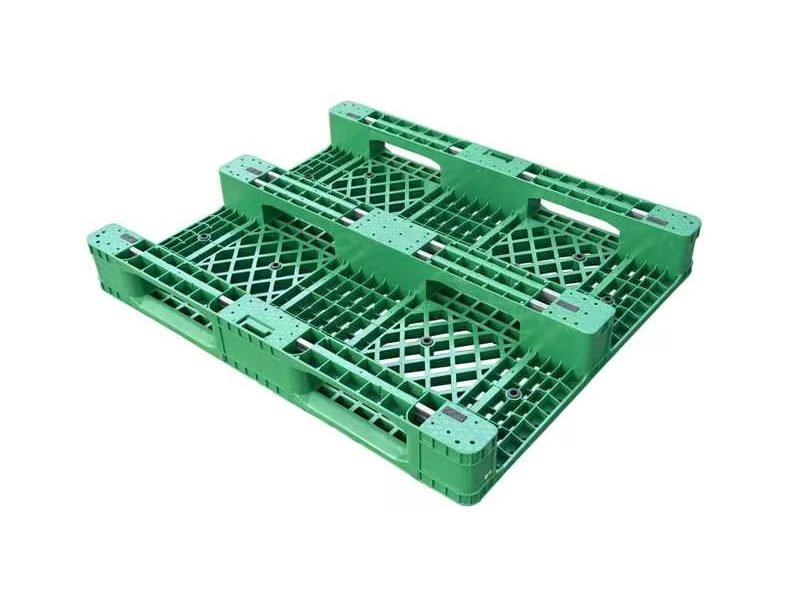 A green Heavy Duty 36 x 60 Plastic Pallet, with a robust build and open - grid pattern, designed to handle heavy loads effectively.